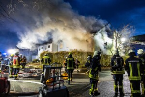 Am Donnerstagmorgen, 04.01.2024 wurde um 07:04 Uhr die Feuerwehr in die Bassenser Straße zu einem Wohnhausbrand gerufen. Beim Eintreffen schlugen den Feuerwehrleuten bereits die Flammen entgegen. Der Brand hatte sich in dem Reihenendhaus über beide Stockwerke und den Dachstuhl ausgebreitet. Umgehend wurde ein umfangreicher Löschangriff vorgenommen. Auch über zwei Drehleitern wurde gelöscht. Während der Brandbekämpfung kam es Durchzündungen, Flammen schlugen meterweit aus dem Gebäude. Ein großes Fensterglas fiel auf die Straße und zersprang in tausende Glassplitter. Bei den Löscharbeiten wurde eine Person tot aufgefunden. Aktuell sind keine weiteren Informationen zur Identität oder Todesumständen bekannt. Die Kriminalpolizei hat die Ermittlungen aufgenommen. Von der Feuerwehr kamen mehrere Löschzüge aus den Nachbargemeinden zum Einsatz. Die Nachlöscharbeiten werden voraussichtlich bis in den Mittag dauern.